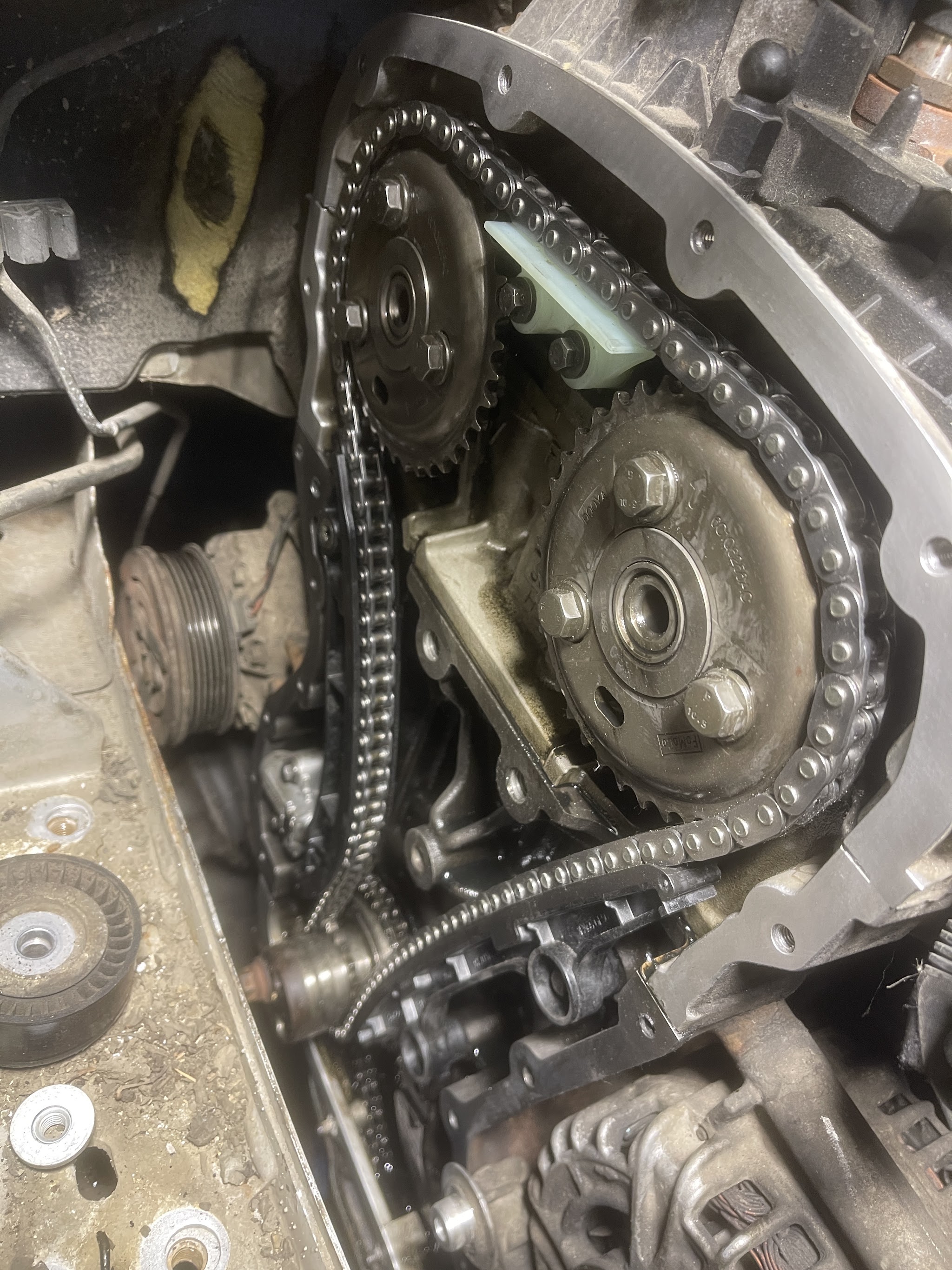 Timing chain and sprockets exposed on an engine during a timing chain replacement